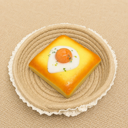 Toast with fried egg topping slow rising squishy with realistic food details.